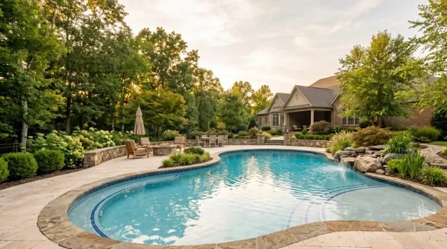 Custom freeform gunite pool with premium plaster finish in a Virginia backyard